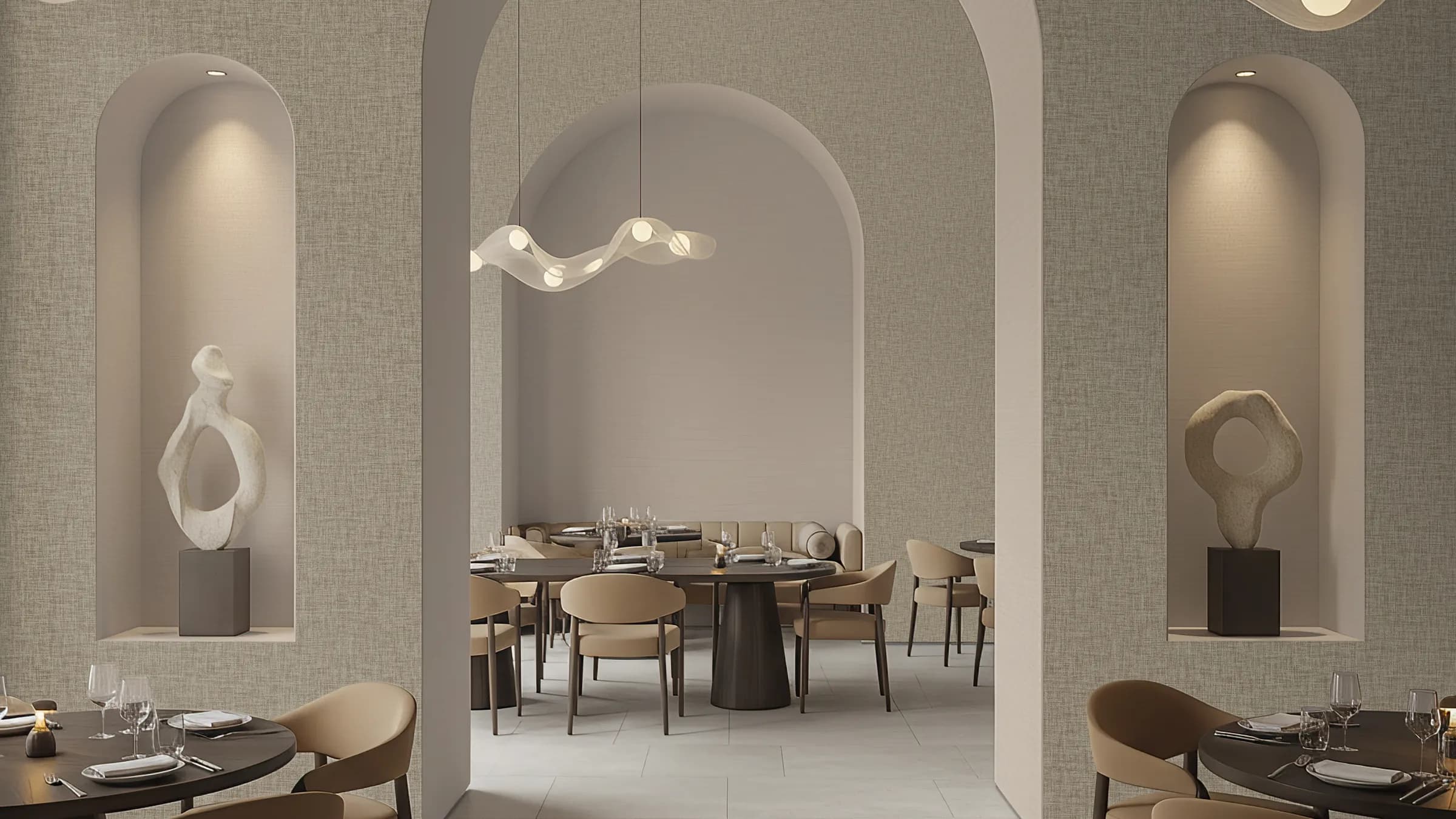 A restaurant with arched alcoves and pale Lienzo wallcovering, set for dinner