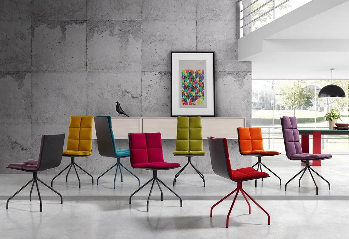 Ara dining chairs in green, yellow, red and purple around a long table