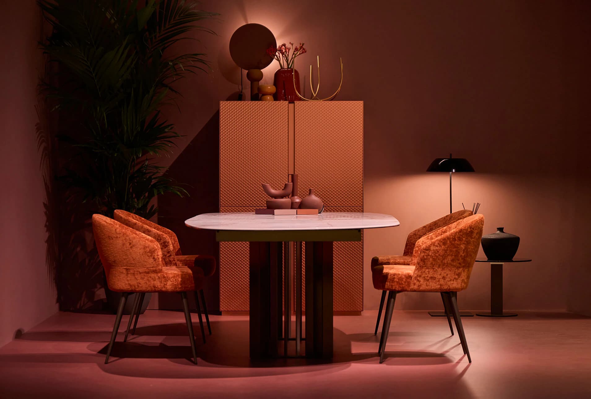 Dressy dining table and upholstered chairs in a warm red interior