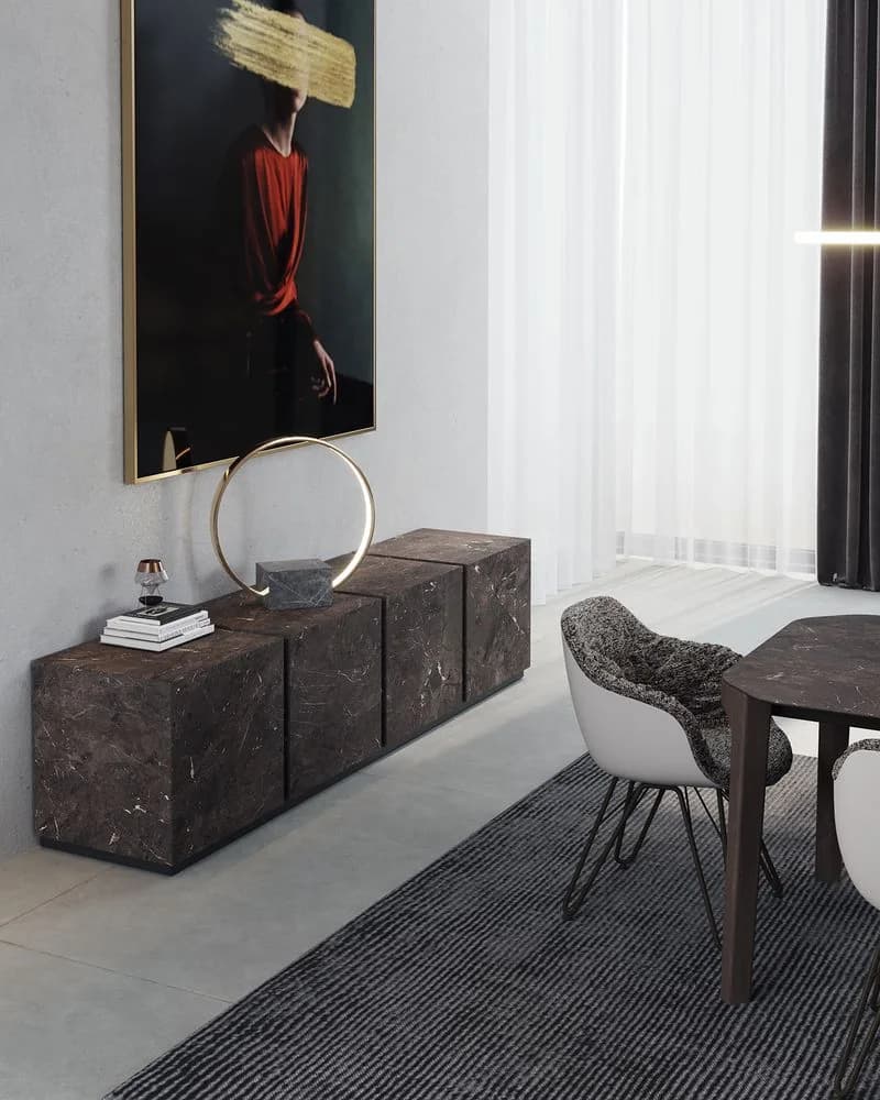 A dark ceramic sideboard beneath a large portrait, with an upholstered dining chair beside it