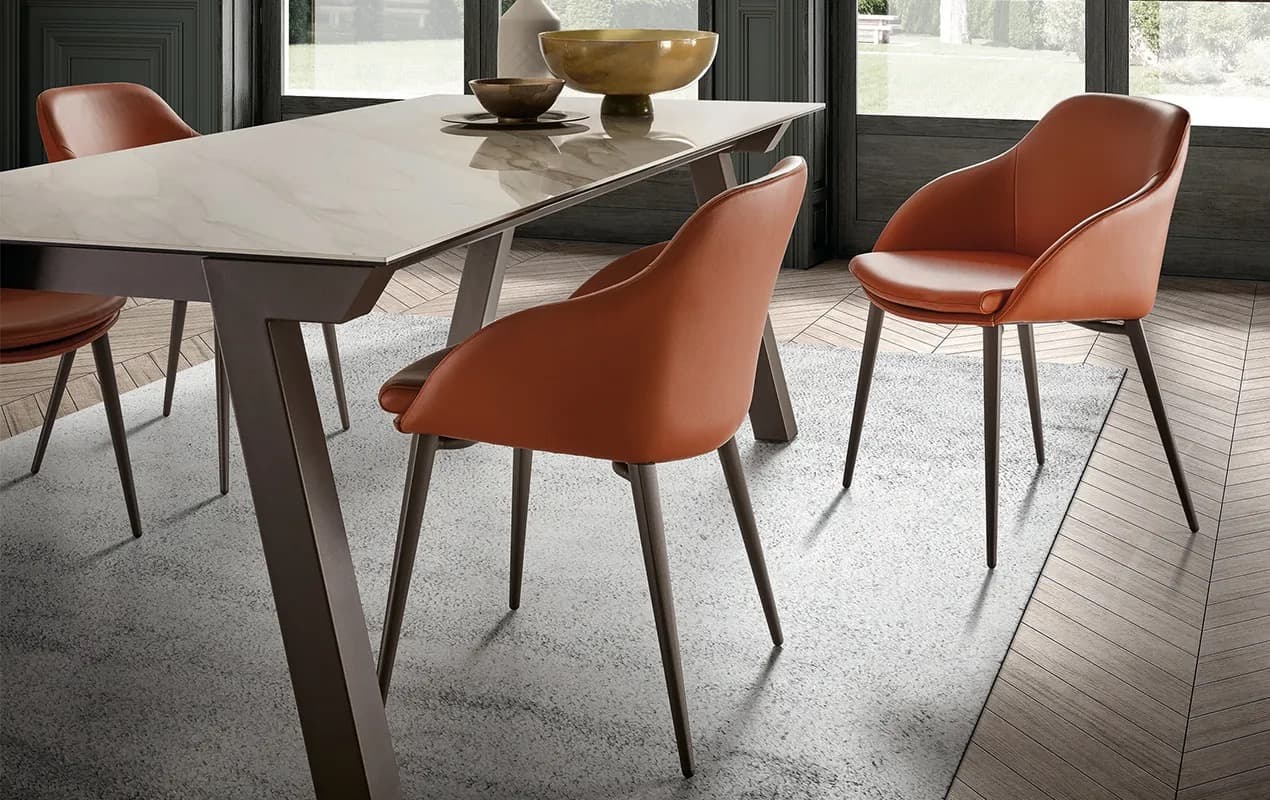Rust-coloured Galera dining chairs around a ceramic table