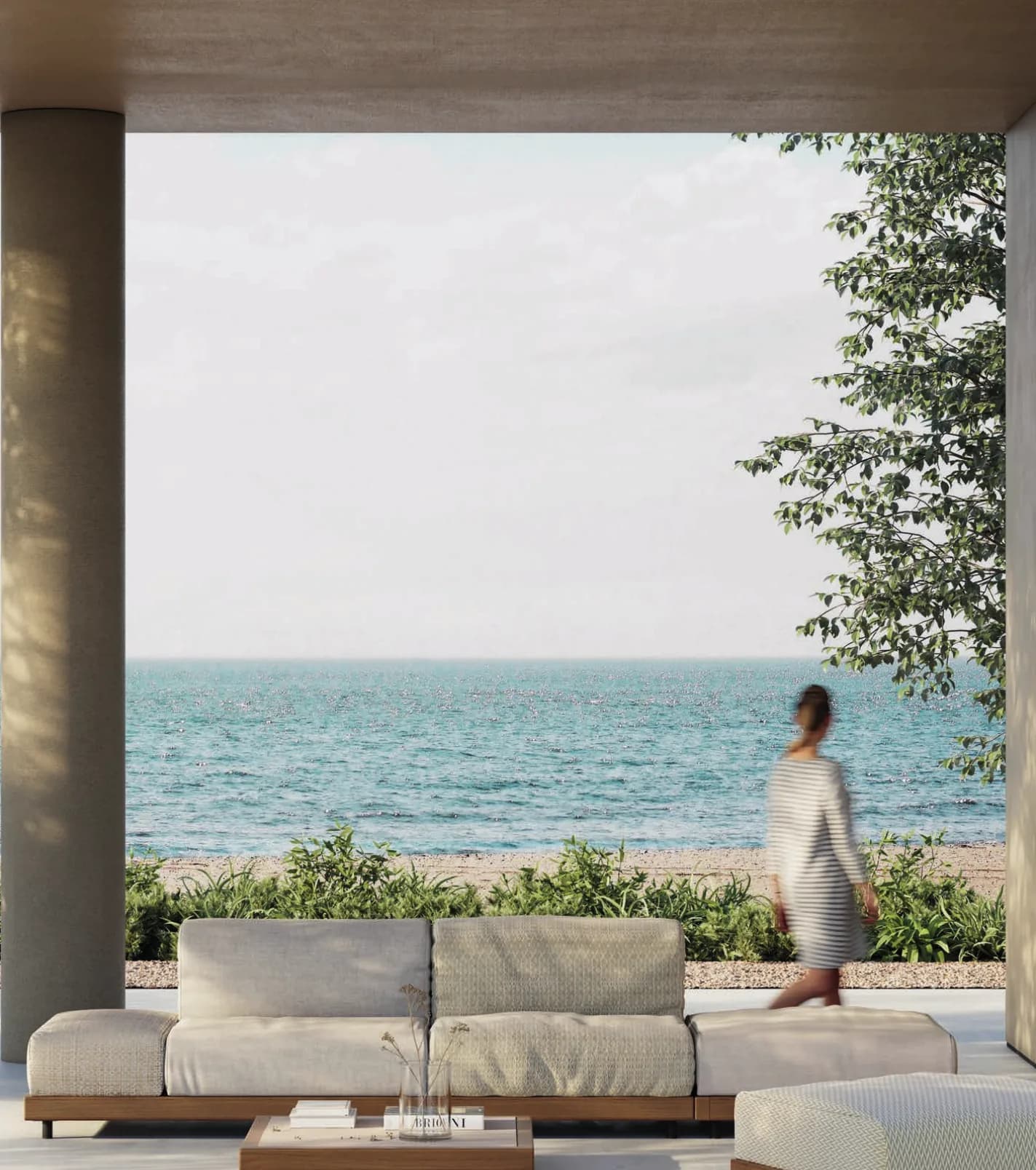 A pale Boira sofa under a covered terrace looking out to the sea