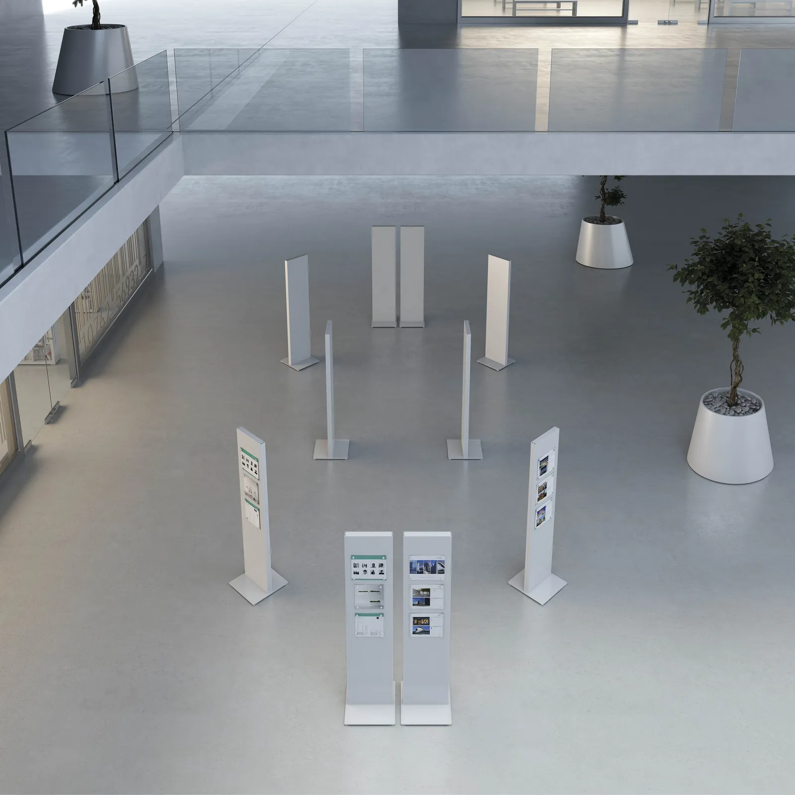 Lit notice panels standing in an open lobby with a planter