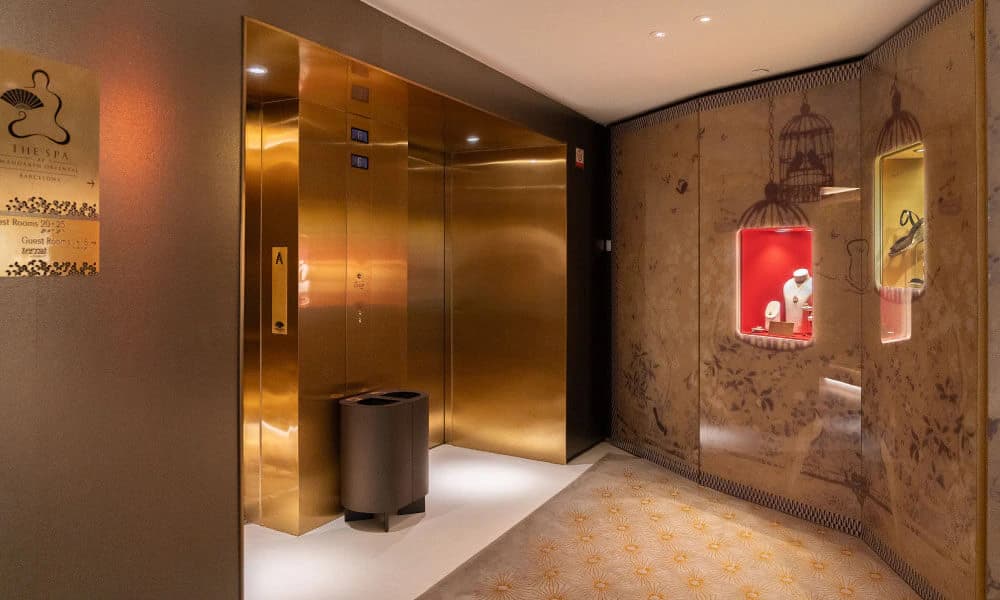 A Croma recycling bin beside the brass lifts at Mandarin Oriental Barcelona